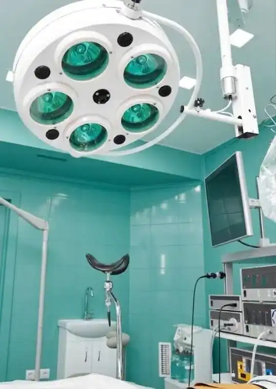 An operating theatre with surgical lighting and monitoring equipment